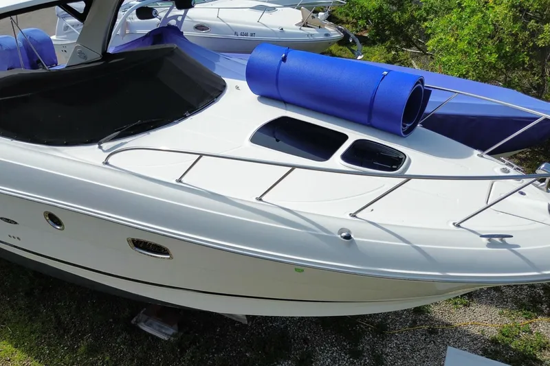 Slide: The Image of 2003 Monterey 302 Cruiser boat with blue accessories on deck, docked outdoors. - 4