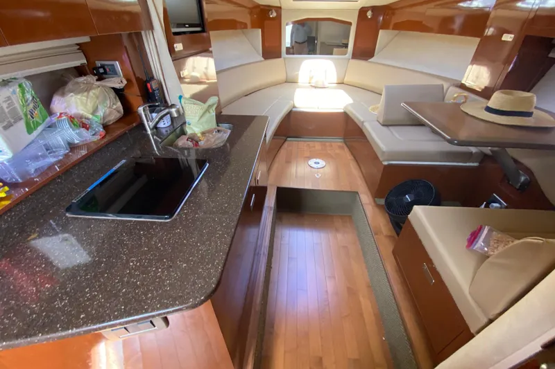 Slide: The Image of Interior of a 2003 Monterey 302 Cruiser with kitchen and seating area. - 43