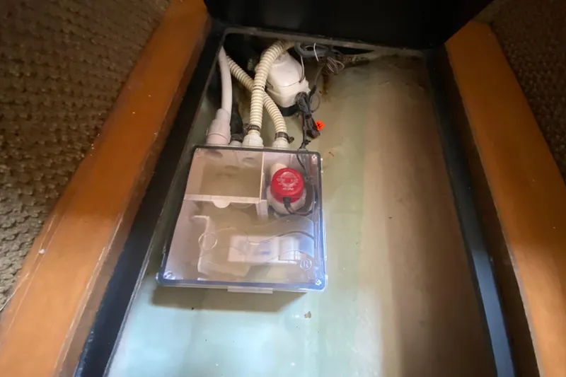Slide: The Image of Electrical compartment in a 2003 Monterey 302 Cruiser boat, featuring wiring and a red switch. - 47