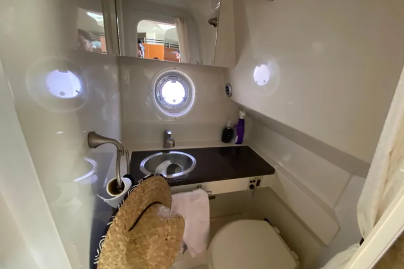 Slide: The Image of Bathroom interior of 2003 Monterey 302 Cruiser with sink, toilet, and porthole window. - 49