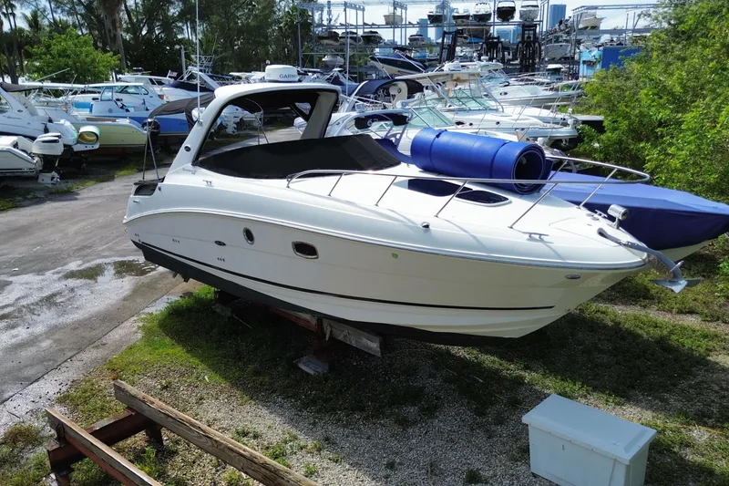 Slide: The Image of 2003 Monterey 302 Cruiser boat on display in a marina with other vessels. - 5