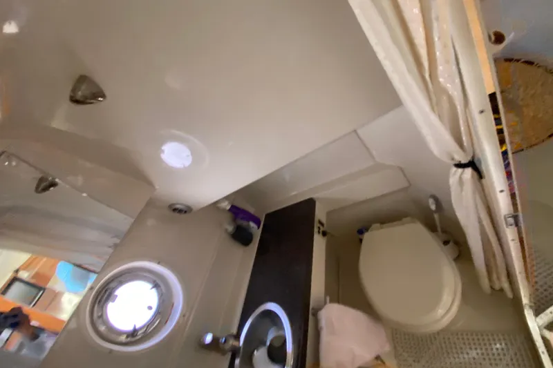 Slide: The Image of Bathroom interior of a 2003 Monterey 302 Cruiser boat with porthole and shower. - 51