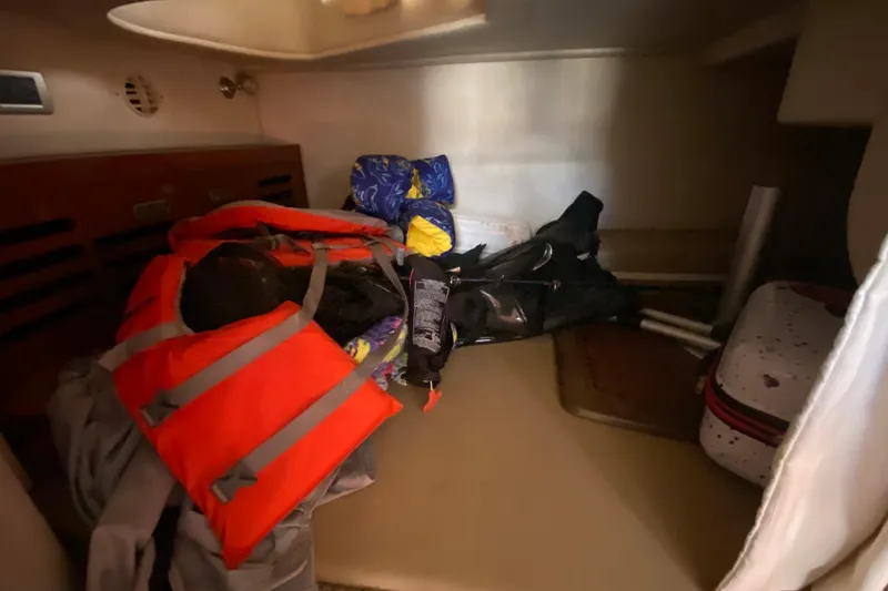 Slide: The Image of Storage area in a 2003 Monterey 302 Cruiser with life jackets and gear. - 52