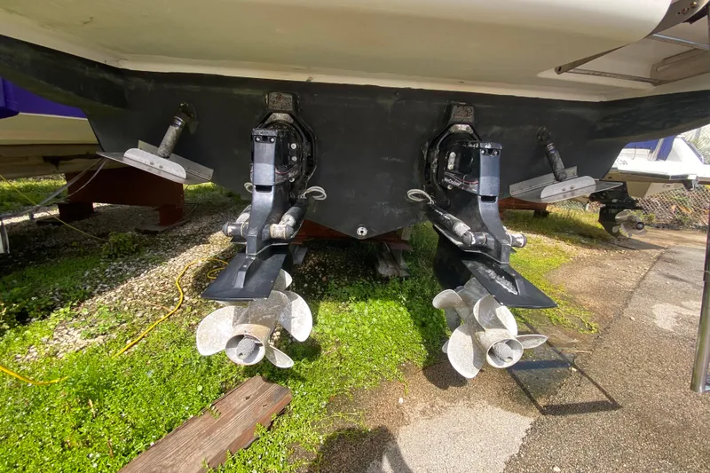 Slide: The Image of Rear view of a 2003 Monterey 302 Cruiser with dual propellers on a boatyard. - 56