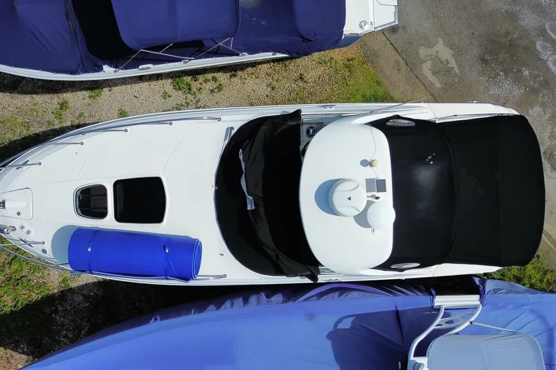 Slide: The Image of Aerial view of a 2003 Monterey 302 Cruiser boat docked with blue and black covers. - 9