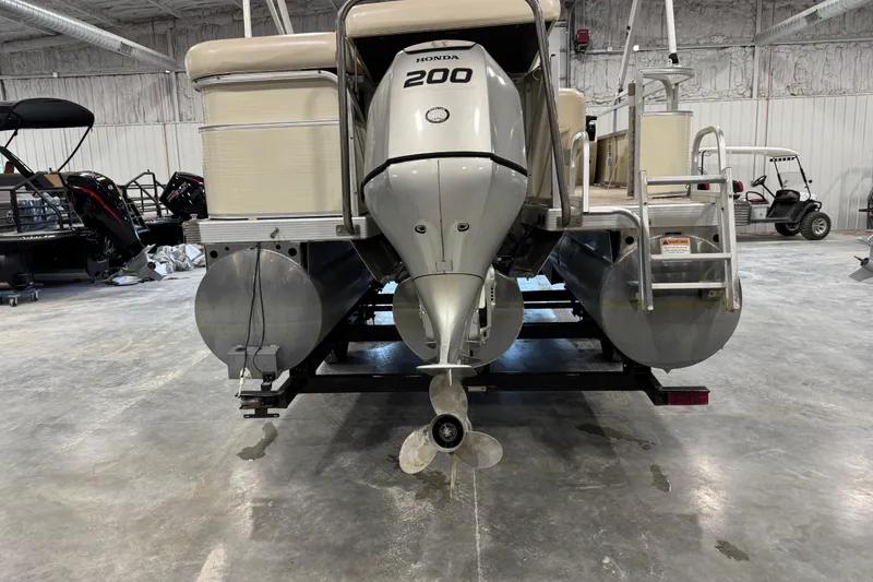 Slide: The Image of 2005 Bennington 2575 RL pontoon boat with Honda 200 outboard motor in a showroom. - 5