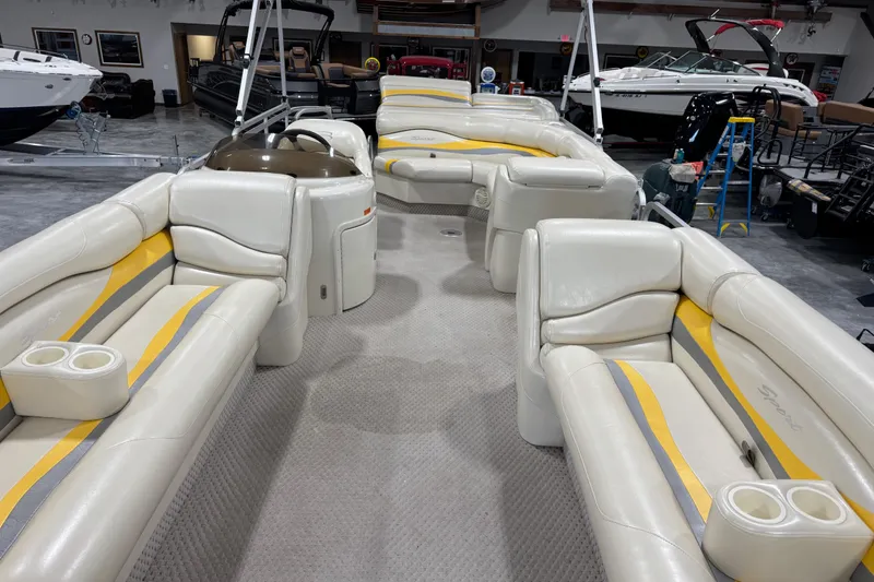 Slide: The Image of Interior of a 2005 Bennington 2575 RL pontoon boat with white and yellow seating. - 7