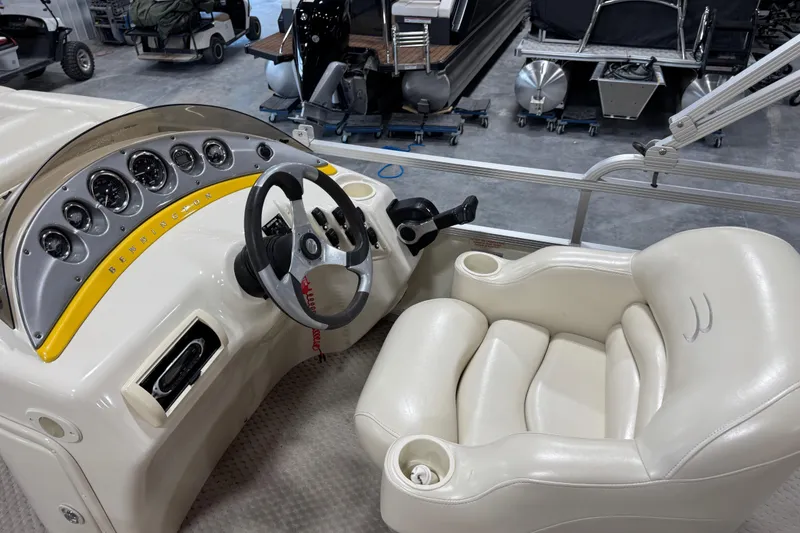 Slide: The Image of 2005 Bennington 2575 RL boat dashboard with steering wheel and plush captain's chair. - 8