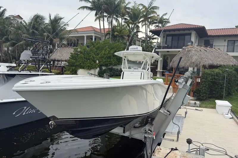 Slide: The Image of 2006 Yellowfin 34 Offshore boat docked near tropical waterfront home. - 33