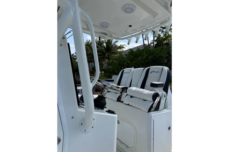 Slide: The Image of 2006 Yellowfin 34 Offshore boat interior with white seating and steering console. - 38