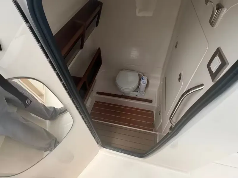 Slide: The Image of Interior of 2026 Grady-White 281 Coastal Explorer with toilet and wood accents. - 10
