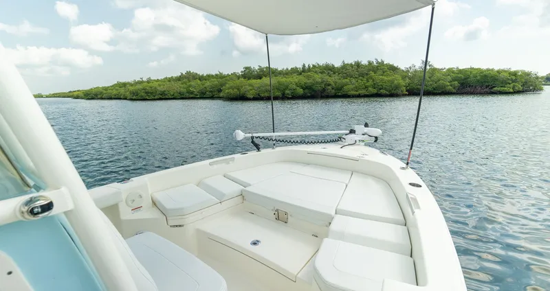 Slide: The Image of Pathfinder 2400 TRS 2026 on calm water with green island in background. - 13