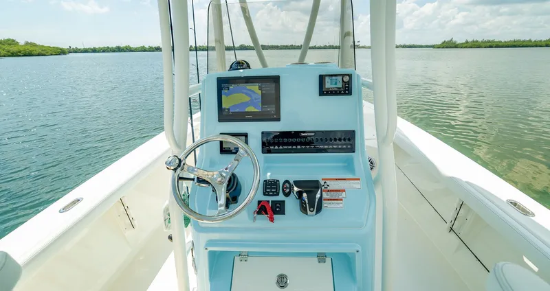Slide: The Image of Interior view of 2026 Pathfinder 2400 TRS boat with helm console. - 6