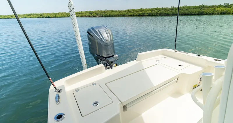 Slide: The Image of Pathfinder 2400 TRS 2026 boat on calm water with outboard motor. - 8
