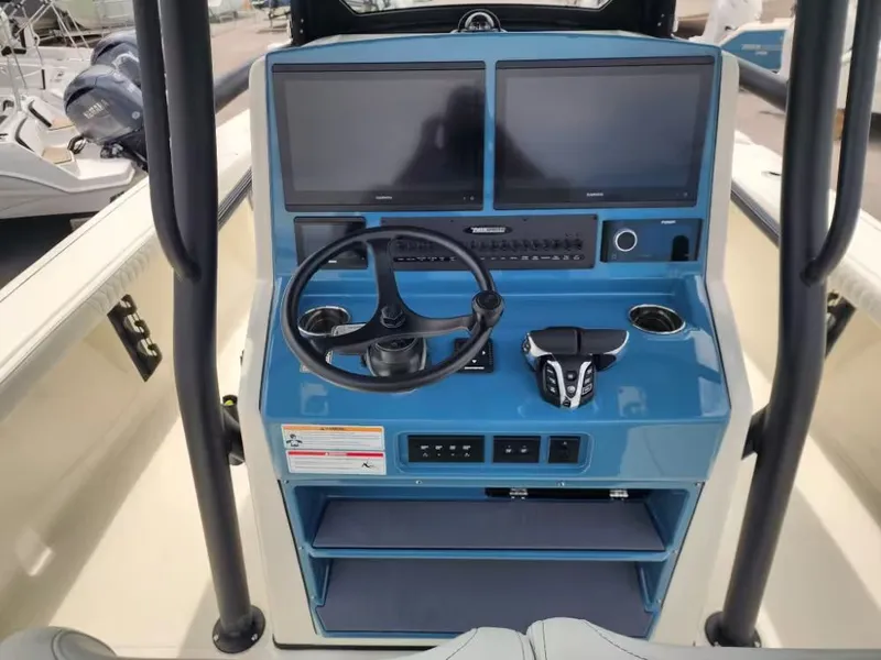 Slide: The Image of Pathfinder 2800 Hybrid 2026 helm with dual screens and controls. - 7