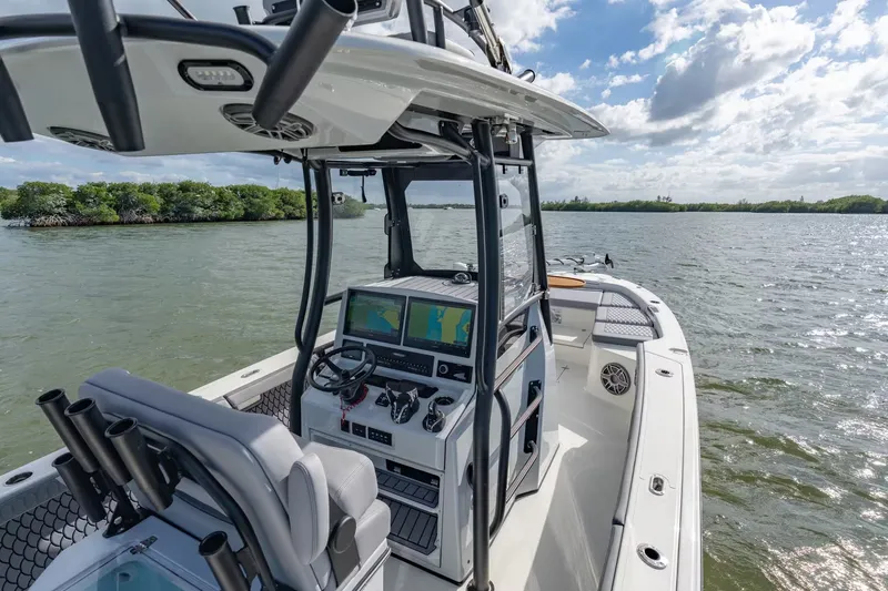 Slide: The Image of Pathfinder 2800 Hybrid 2026 on calm waters with modern helm console. - 11