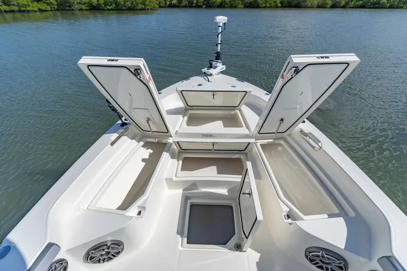 Slide: The Image of Pathfinder 2800 Hybrid 2026 with open storage compartments on water. - 16