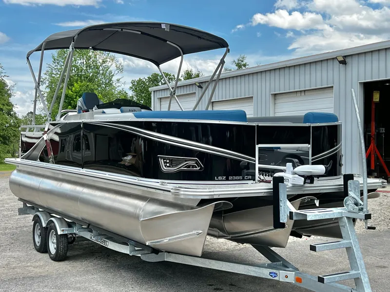 Slide: The Image of 2026 Avalon LSZ 23' Cruise Triple-Toon on trailer, in storage facility. - 7