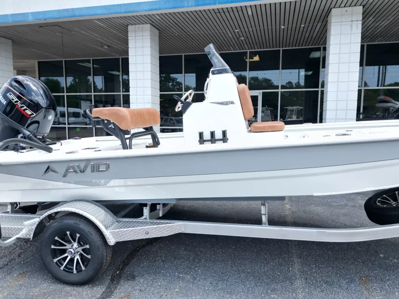 Slide: The Image of 2026 Avid 19 FSX boat on trailer in front of building. - 3