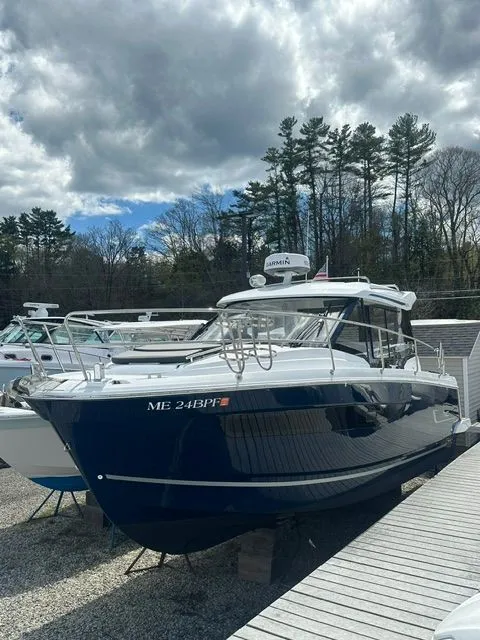 The Image of 2021 Jeanneau NC 895 boat on a dock, cloudy sky. - 1