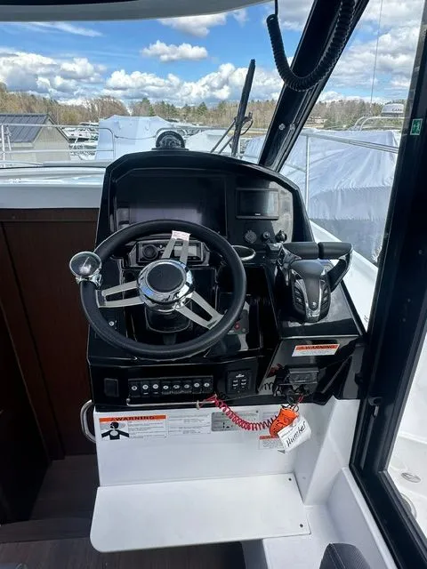Slide: The Image of Jeanneau NC 895 helm station, 2021 model, featuring modern controls. - 11