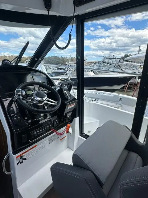 Slide: The Image of Interior view of Jeanneau NC 895 cockpit, 2021 model, featuring steering wheel and seat. - 12