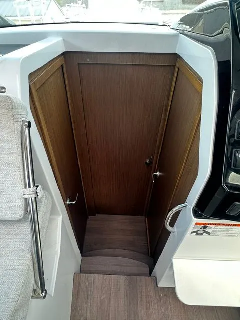 Slide: The Image of Interior of Jeanneau NC 895, featuring wooden door and stairs. - 16