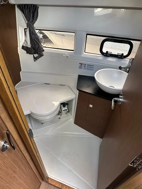 Slide: The Image of Interior of Jeanneau NC 895 yacht, bathroom with toilet and sink. - 18