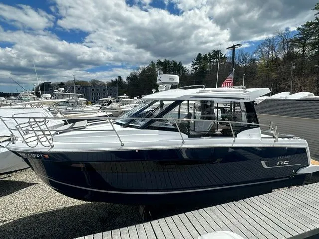 Slide: The Image of 2021 Jeanneau NC 895 motorboat docked, cloudy sky. - 2