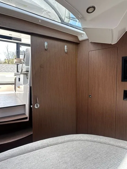 Slide: The Image of Interior of 2021 Jeanneau NC 895 yacht with wood paneling and cushioned seating. - 20