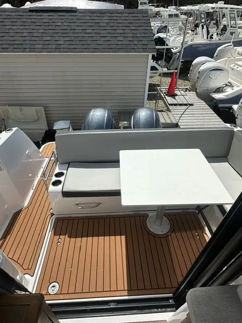 Slide: The Image of Jeanneau NC 895 2021 with seating area and table on teak deck. - 6