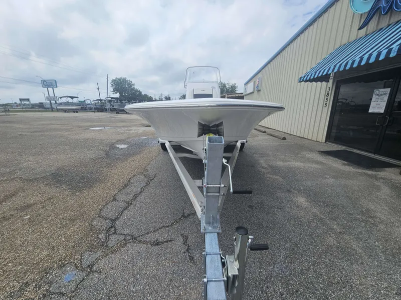 Slide: The Image of 2026 Tidewater 2110BMT boat on trailer outside building. - 3