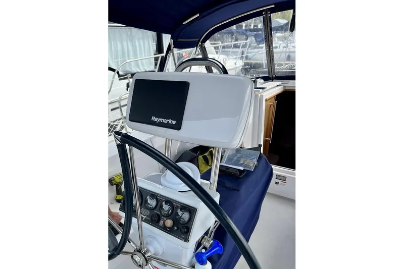 Slide: The Image of Cockpit of 2012 Catalina 355 sailboat with Raymarine navigation system and steering wheel. - 10