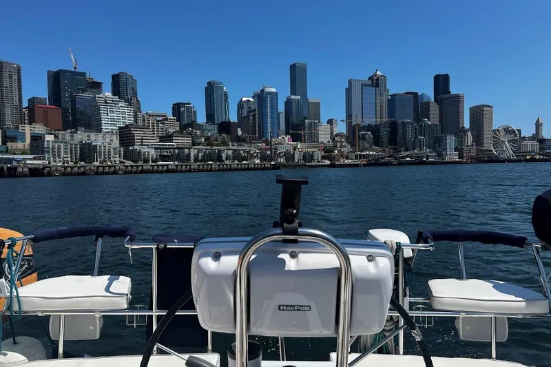 Slide: The Image of Sailboat Catalina 355 on water with city skyline and Ferris wheel in background. - 12
