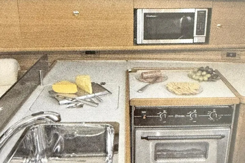 Slide: The Image of Galley kitchen in 2011 Catalina 355 yacht with stove, sink, and microwave. - 15