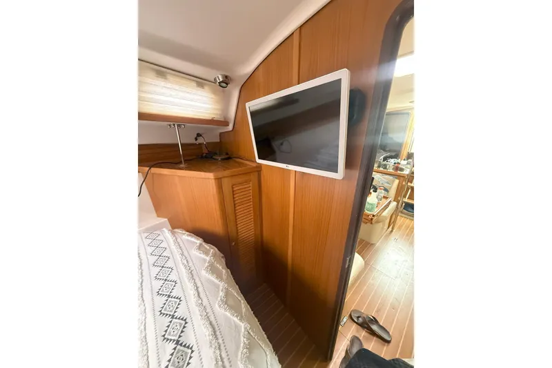 Slide: The Image of Interior of 2012 Catalina 355 yacht with wood paneling and mounted TV. - 18