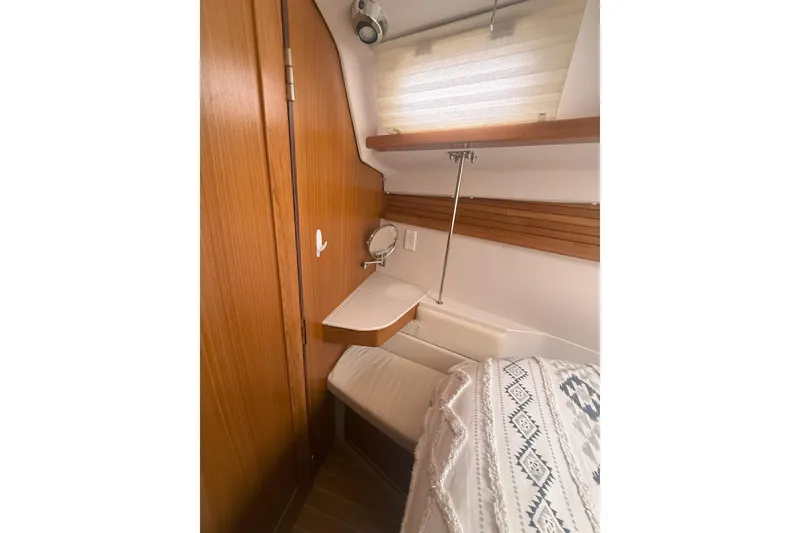 Slide: The Image of Cozy interior of 2012 Catalina 355 sailboat with wooden accents and comfortable seating. - 19