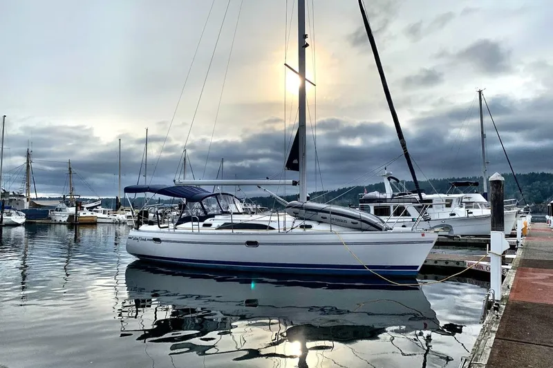 Slide: The Image of Sailboat Catalina 355, 2012 model, docked at a marina under a cloudy sky. - 2