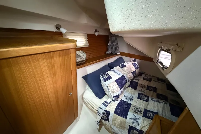 Slide: The Image of Cozy cabin interior of 2011 Catalina 355 sailboat with nautical-themed bedding. - 20