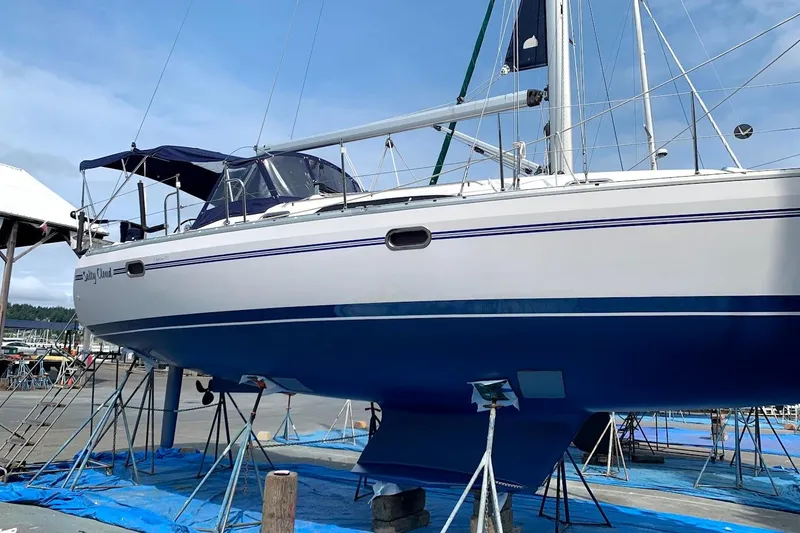 Slide: The Image of 2012 Catalina 355 sailboat on stands, blue hull, marina background. - 24