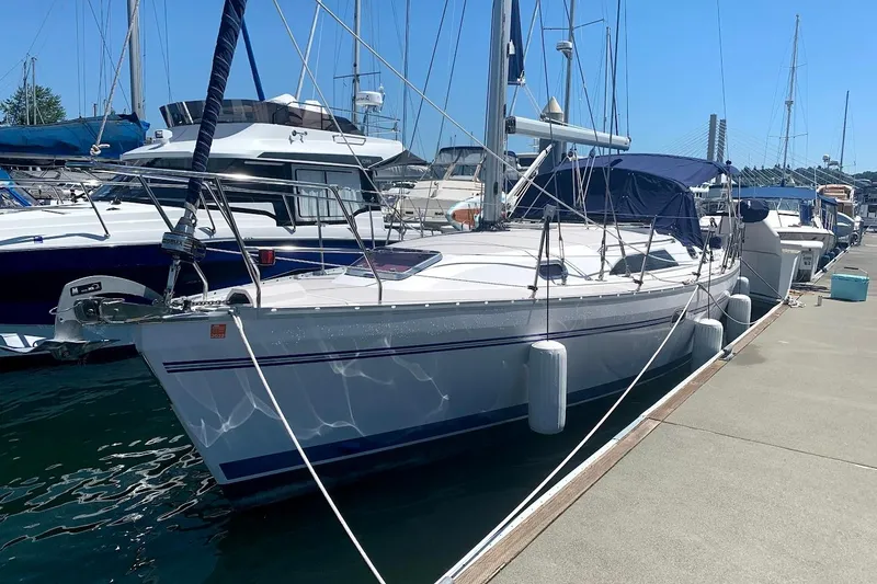 Slide: The Image of Sailboat Catalina 355, 2012 model, docked at marina under clear blue sky. - 3