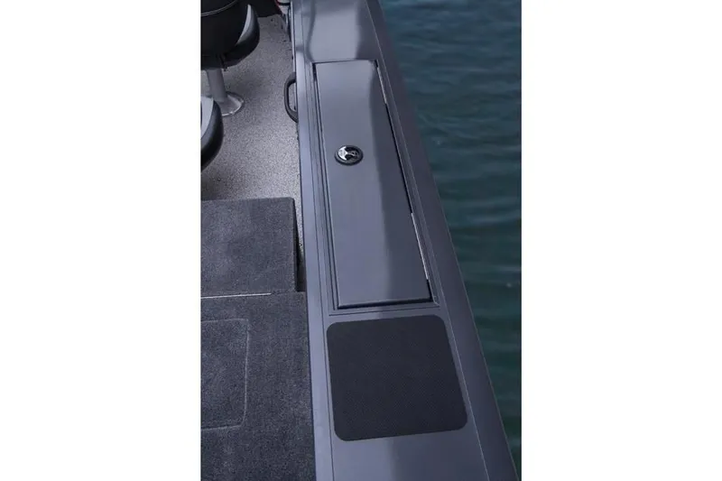 Slide: The Image of 2014 Tracker Targa V-18 Combo boat deck with storage compartment. - 19