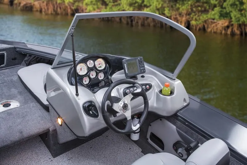 Slide: The Image of 2014 Tracker Targa V-18 Combo boat dashboard with instruments and cup holder. - 24