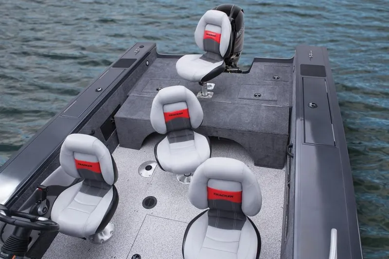 Slide: The Image of 2014 Tracker Targa V-18 Combo boat with gray seats on water. - 27
