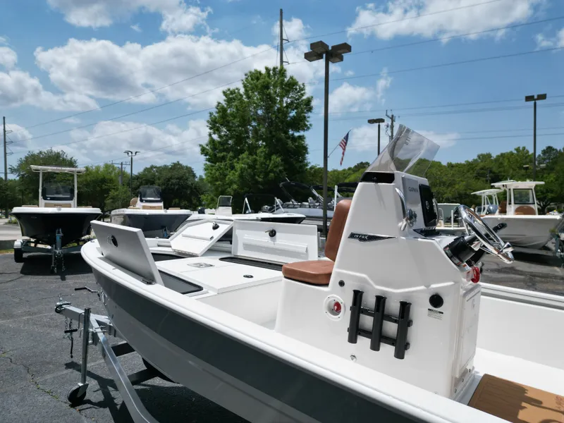 Slide: The Image of 2026 Avid 19 FSX boat on a parking lot under sunny skies. - 12