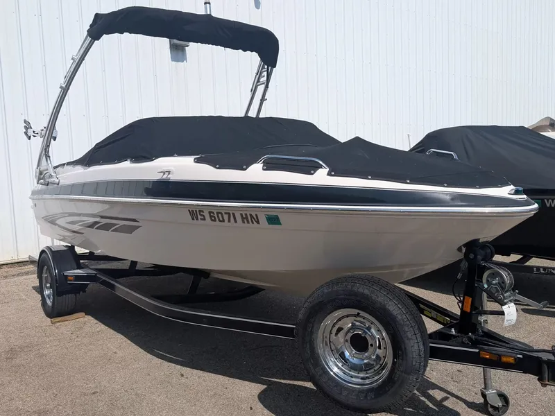 The Image of 2008 Glastron GT 205 boat with cover on trailer. - 1