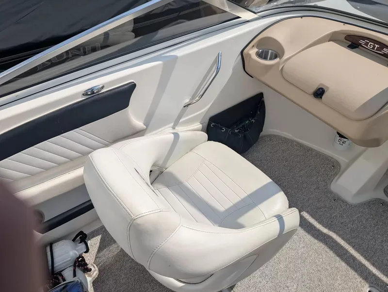 Slide: The Image of Interior of a 2008 Glastron GT 205 boat with beige seating. - 12