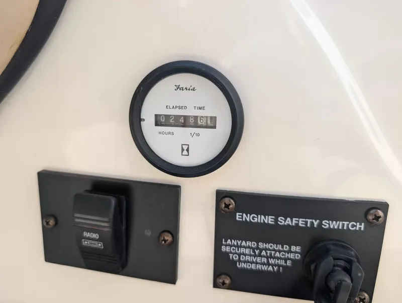 Slide: The Image of 2008 Glastron GT 205 boat dashboard with hour meter and safety switch. - 14