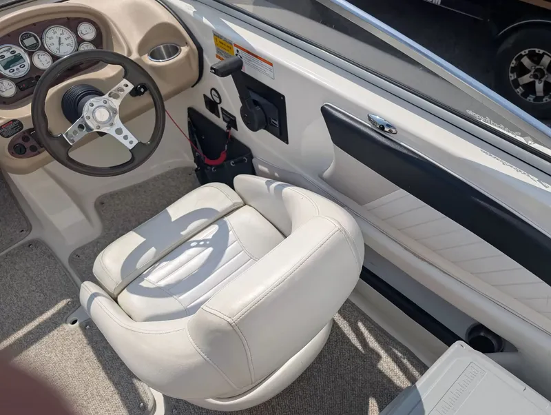 Slide: The Image of Interior of a 2008 Glastron GT 205 boat with steering wheel and seat. - 9