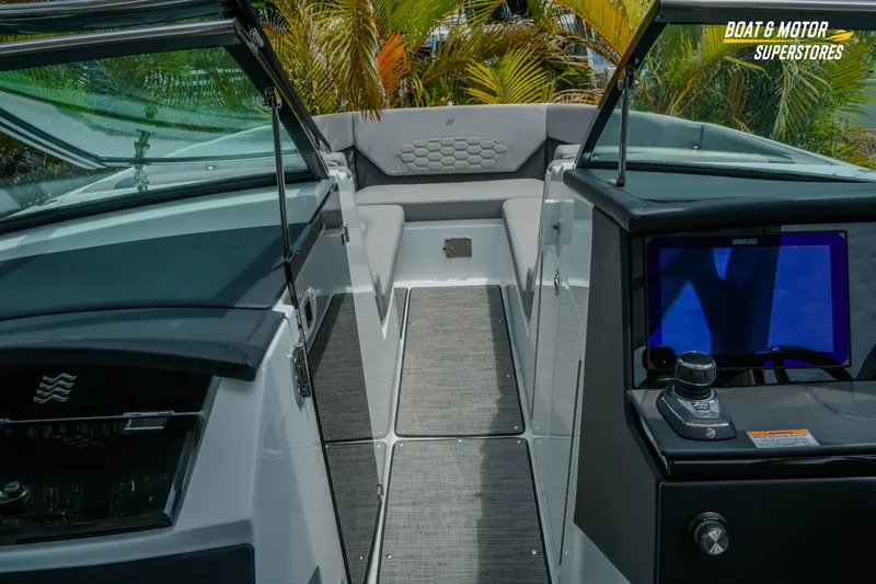 Slide: The Image of Interior view of 2026 Four Winns H9 OB boat with modern dashboard and seating. - 10